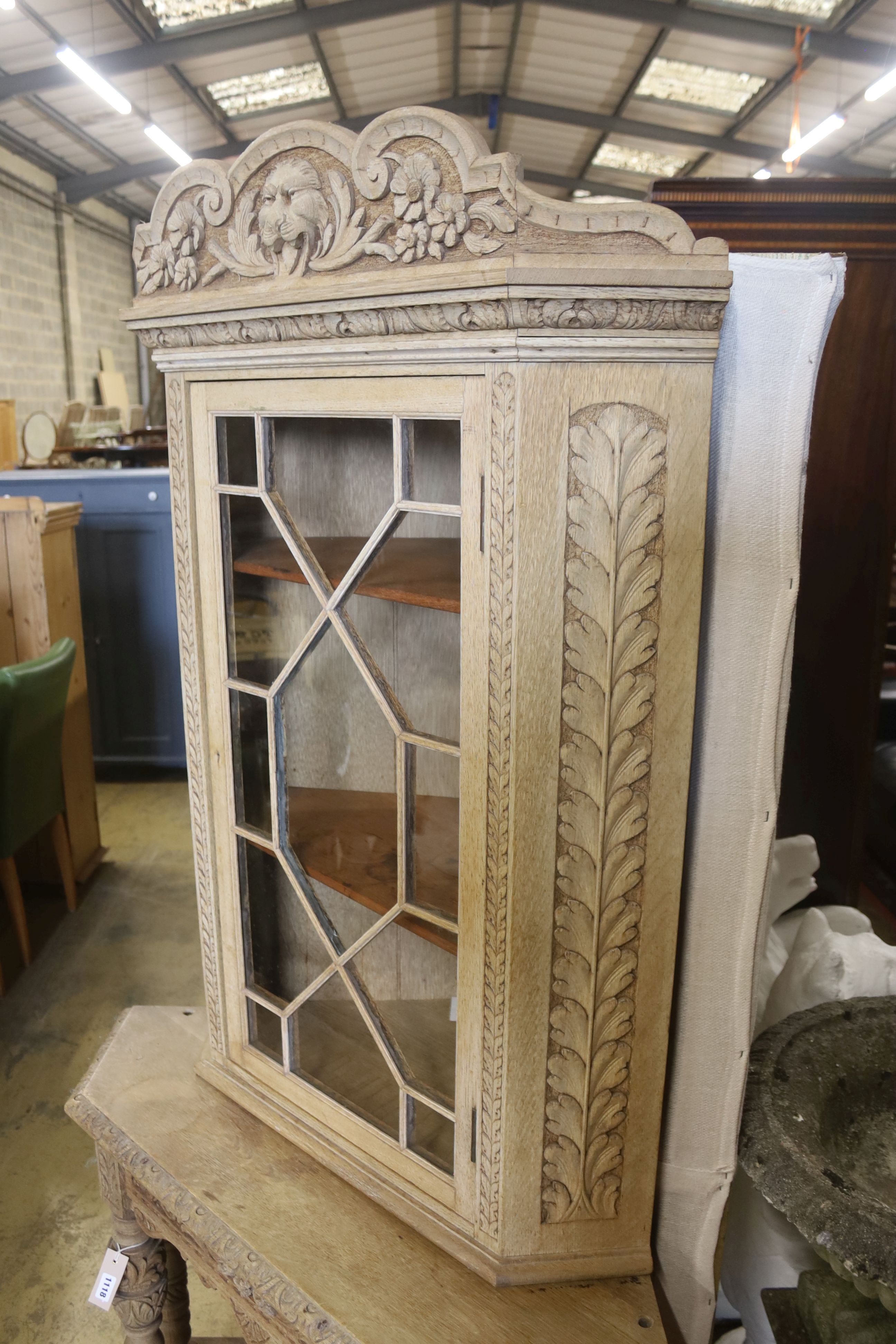 A Flemish bleached oak corner cabinet, width 98cm, depth 70cm, height 190cm